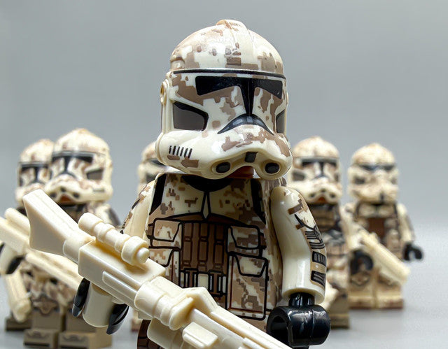 Close-up of a desert digital camo phase 2 clone trooper holding a blaster rifle
